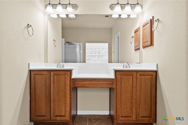 bathroom featuring vanity, tile patterned floors, and a shower with door