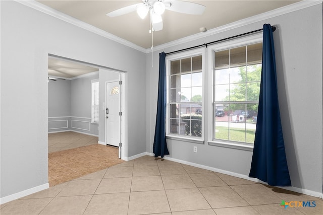 tiled spare room featuring ceiling fan and ornamental molding