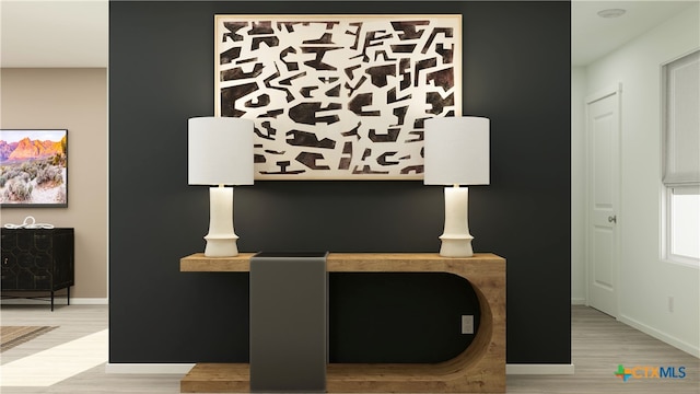 home office with baseboards and wood finished floors