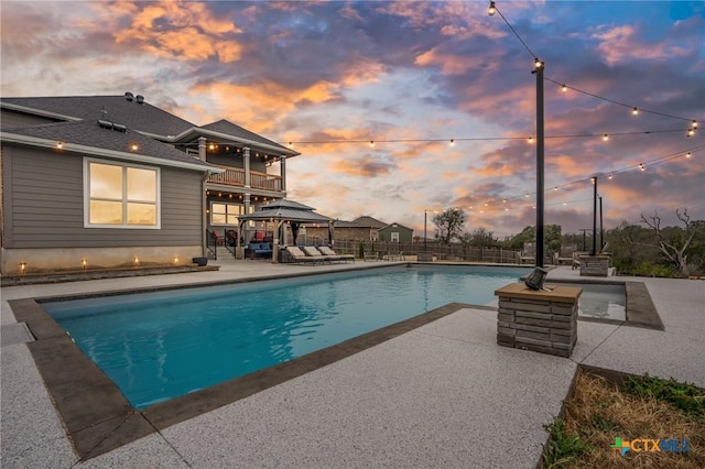 view of swimming pool featuring a patio, a gazebo, fence, and a fenced in pool