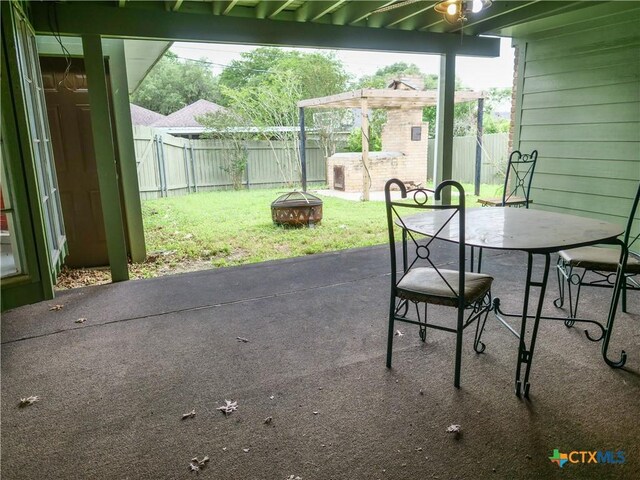 view of patio with a pergola, a fire pit, and a fenced backyard
