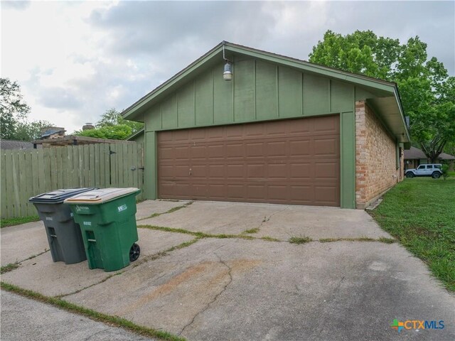 detached garage featuring a gate and fence