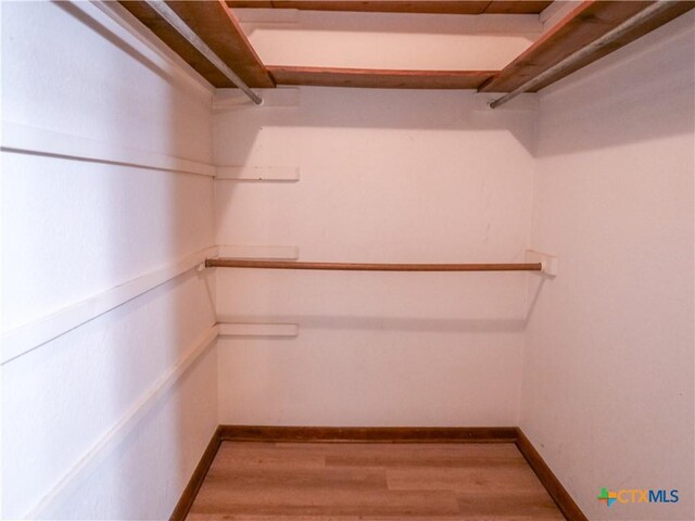 spacious closet with wood finished floors