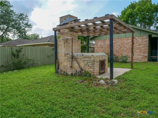 view of side of property with a lawn, brick siding, fence, and a chimney