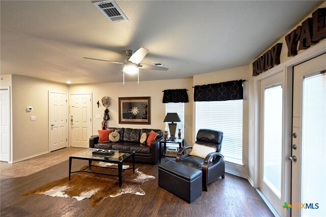 living room with ceiling fan and dark hardwood / wood-style floors