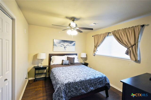 bedroom featuring a closet, ceiling fan, and dark hardwood / wood-style floors