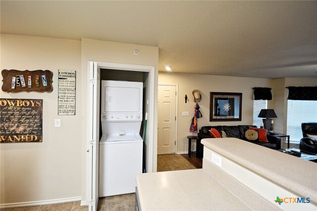 interior space with stacked washing maching and dryer