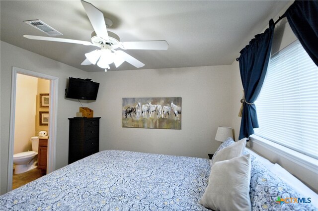 bedroom featuring ceiling fan and ensuite bathroom