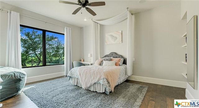 bedroom with ceiling fan and dark hardwood / wood-style floors