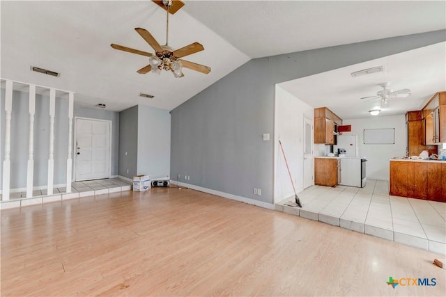 unfurnished living room featuring lofted ceiling, light wood-style floors, ceiling fan, and visible vents