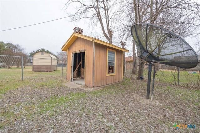 view of shed featuring fence