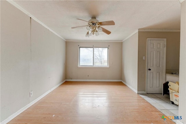 unfurnished bedroom featuring light wood-type flooring, baseboards, ornamental molding, and a textured ceiling