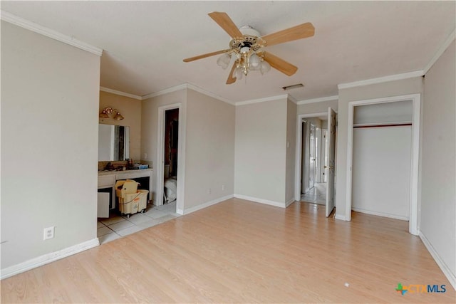 unfurnished bedroom featuring ornamental molding, visible vents, light wood-style flooring, and baseboards