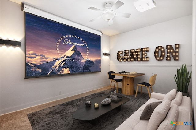 carpeted home theater room featuring ceiling fan