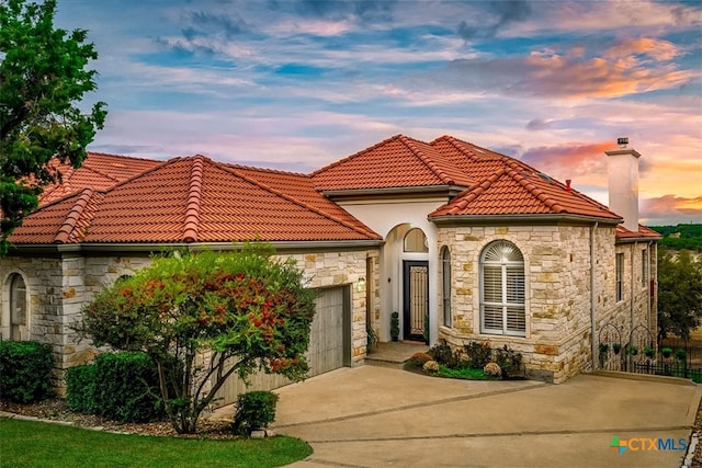 mediterranean / spanish-style house featuring a garage