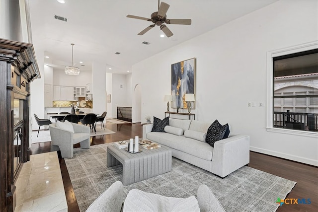 living room featuring ceiling fan, a fireplace, and hardwood / wood-style floors