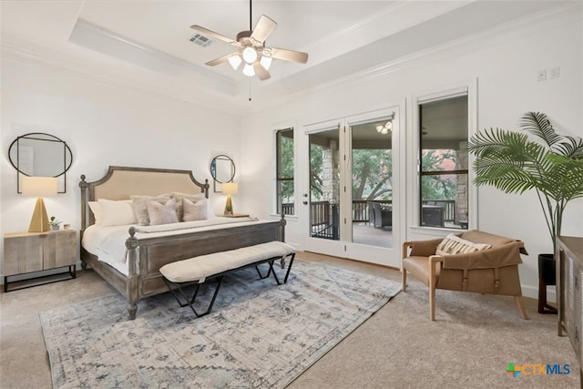 bedroom with crown molding, ceiling fan, a tray ceiling, and access to exterior