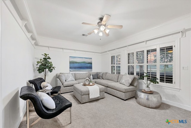 living room with ornamental molding, carpet flooring, and ceiling fan