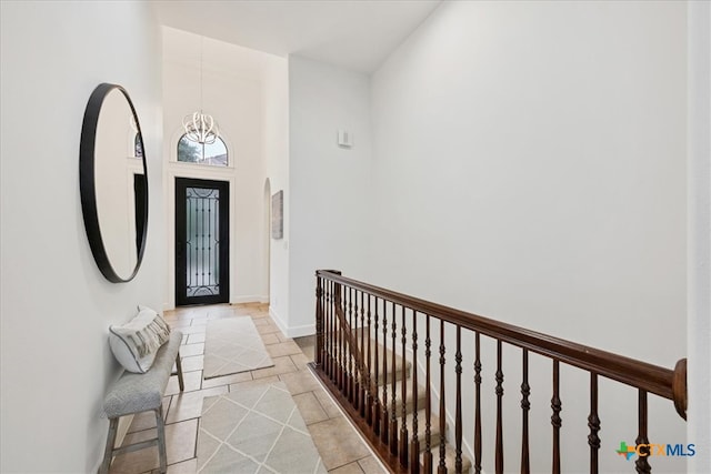 entryway featuring a chandelier and a high ceiling