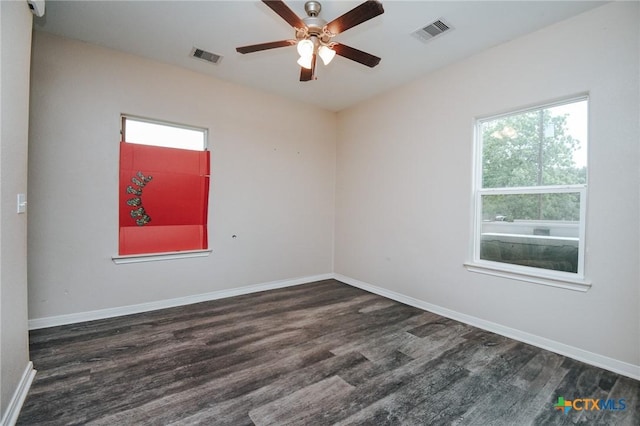 spare room featuring visible vents, a healthy amount of sunlight, and wood finished floors