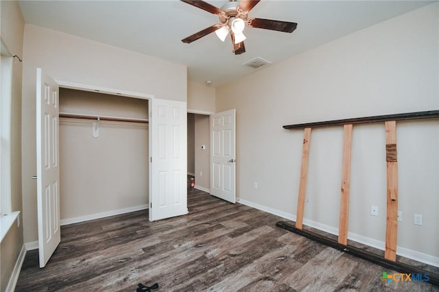 unfurnished bedroom featuring ceiling fan, baseboards, wood finished floors, visible vents, and a closet