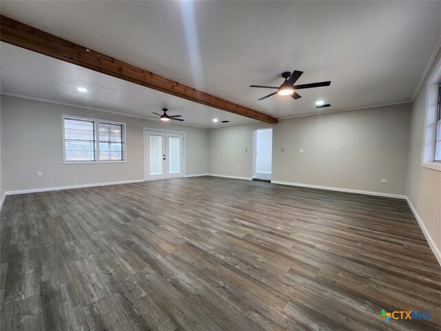 unfurnished living room featuring baseboards, ornamental molding, dark wood-style flooring, french doors, and beam ceiling