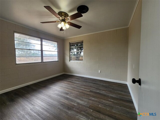 spare room with ceiling fan, baseboards, dark wood-style flooring, and crown molding