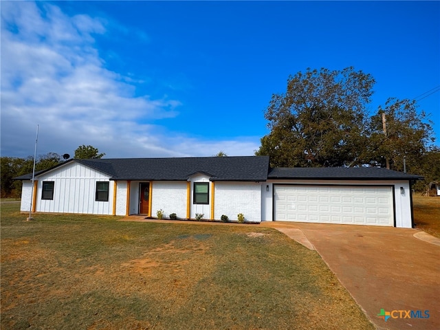 single story home featuring a garage and a front yard