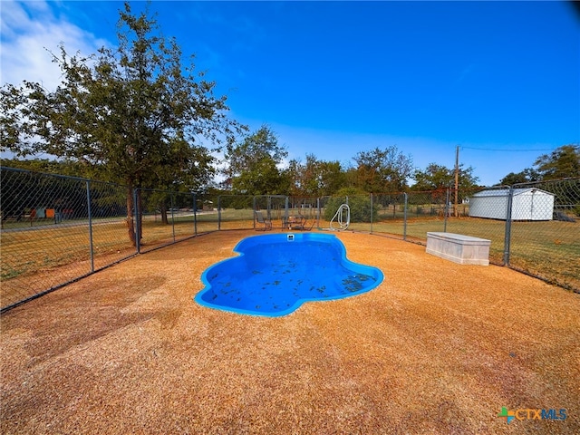 view of pool featuring a yard