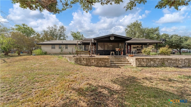 back of house with a patio area and a yard