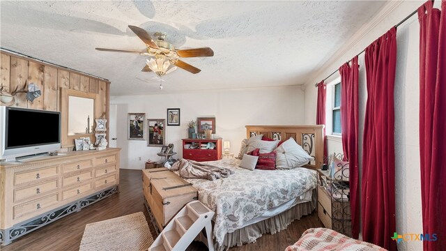 bedroom with a textured ceiling, ceiling fan, and dark hardwood / wood-style floors