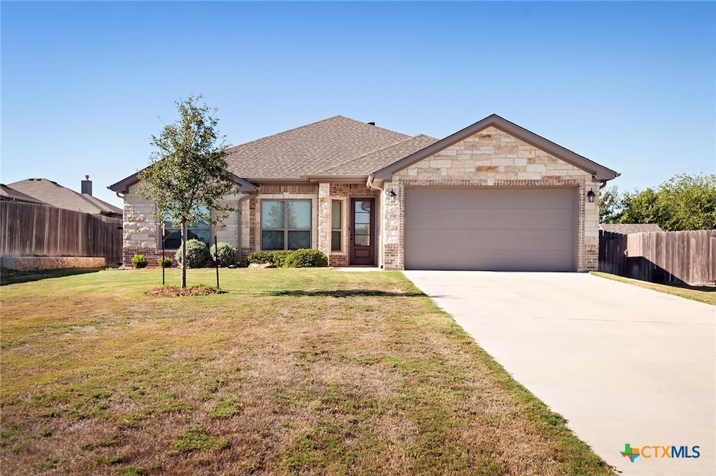 view of front facade with a garage and a front lawn