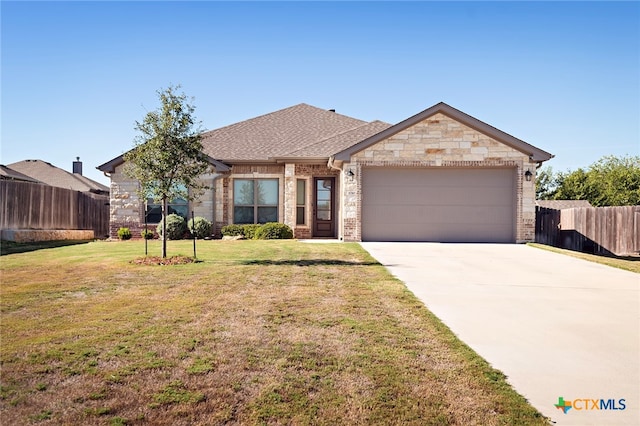 view of front facade with a garage and a front lawn