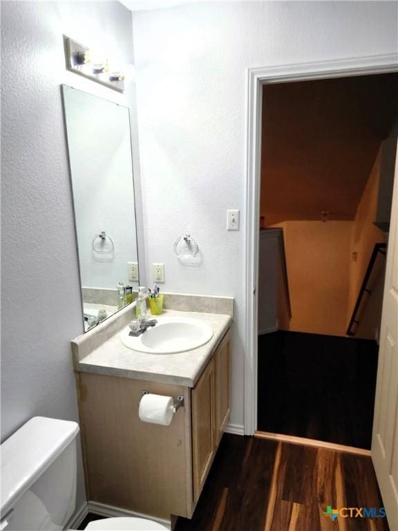 1402 Fox Creek Dr, Killeen, TX 76543 - bathroom featuring toilet, wood finished floors, and vanity