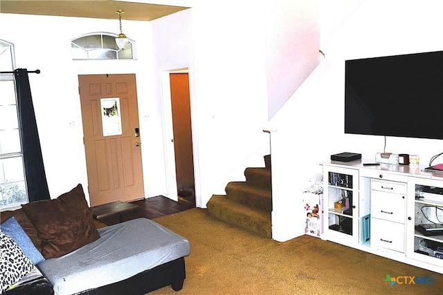 carpeted entryway with stairs