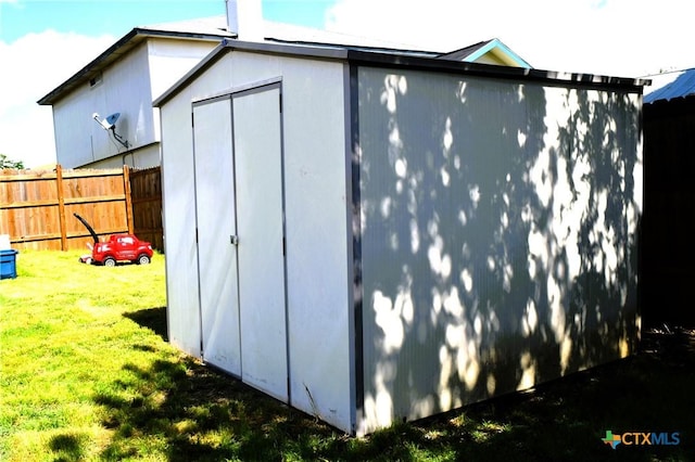 view of shed with fence