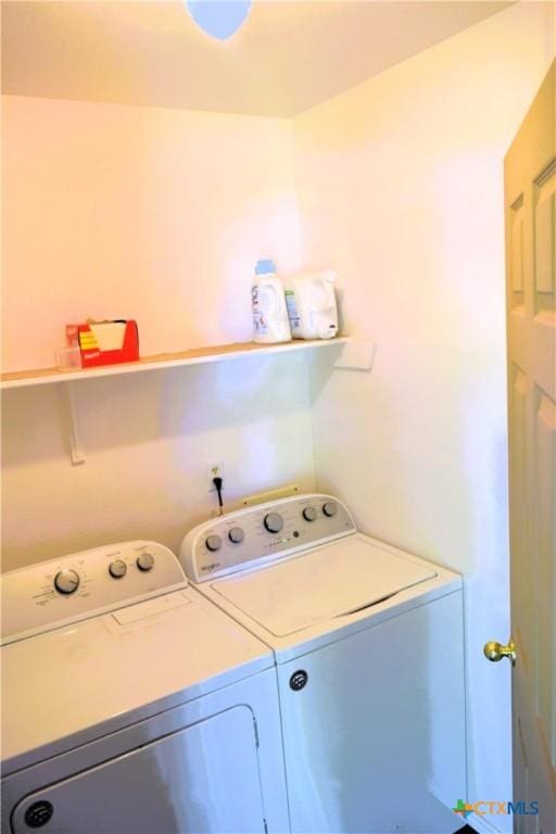 washroom with separate washer and dryer and laundry area