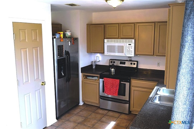kitchen with visible vents, electric stove, a sink, white microwave, and refrigerator with ice dispenser