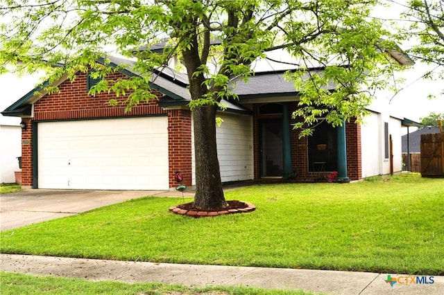 view of front of home featuring fence, an attached garage, driveway, brick siding, and a front yard