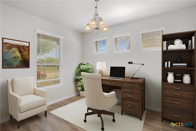 office space with light wood-type flooring and a notable chandelier