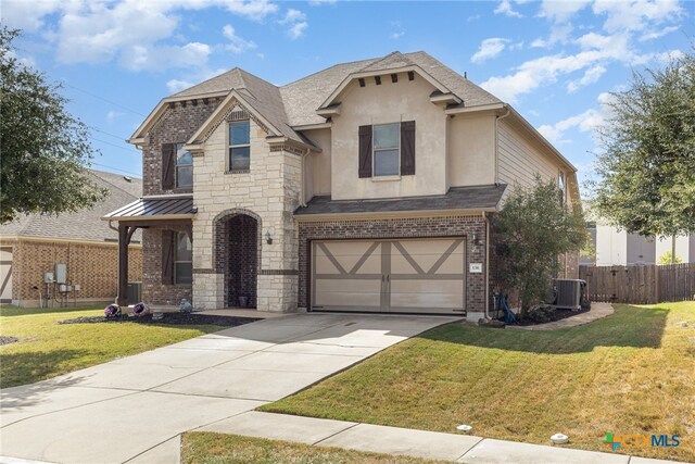 view of front of home featuring central AC unit, a garage, and a front yard