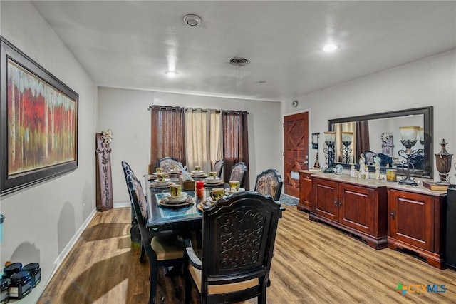 dining space with light hardwood / wood-style floors