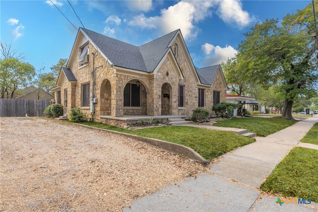 english style home with a front yard