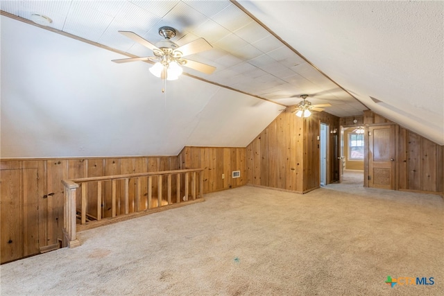 additional living space featuring lofted ceiling, ceiling fan, and carpet floors