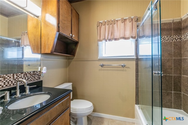 full bathroom with a wealth of natural light, vanity, combined bath / shower with glass door, and tile patterned floors