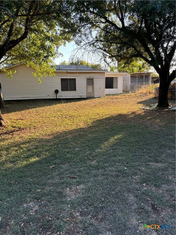 back of house with a yard