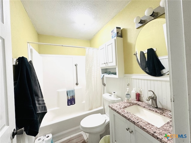 full bathroom with toilet, shower / bath combo, vanity, and a textured ceiling