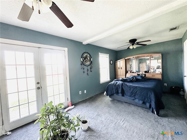 bedroom with ceiling fan, multiple windows, and beam ceiling