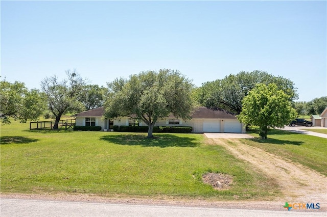 view of front of home featuring a front yard and dirt driveway