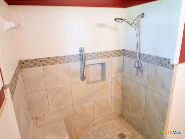 bathroom with tiled shower